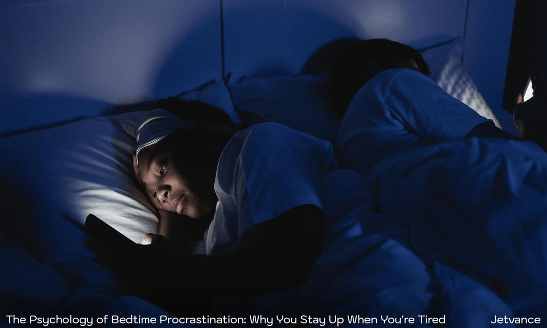 Woman scrolling on her phone in bed late at night with lights off